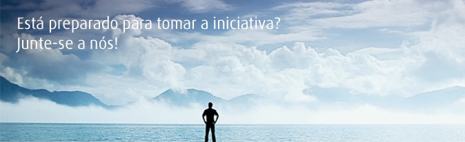 Picture of man standing in a panoramic landscape with a cloudy sky. Translated to Portuguese.